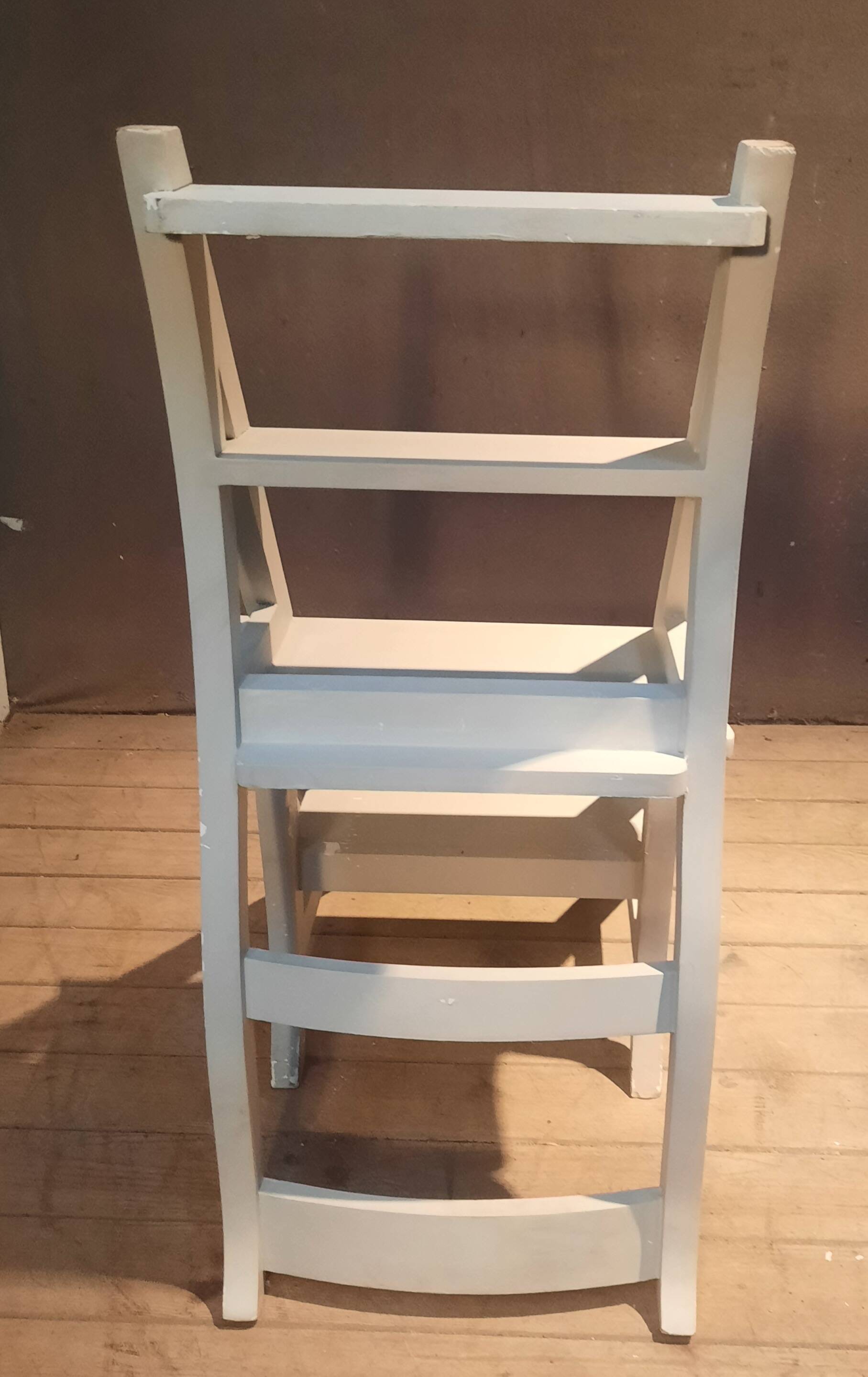 White chair convertible into a staircase.