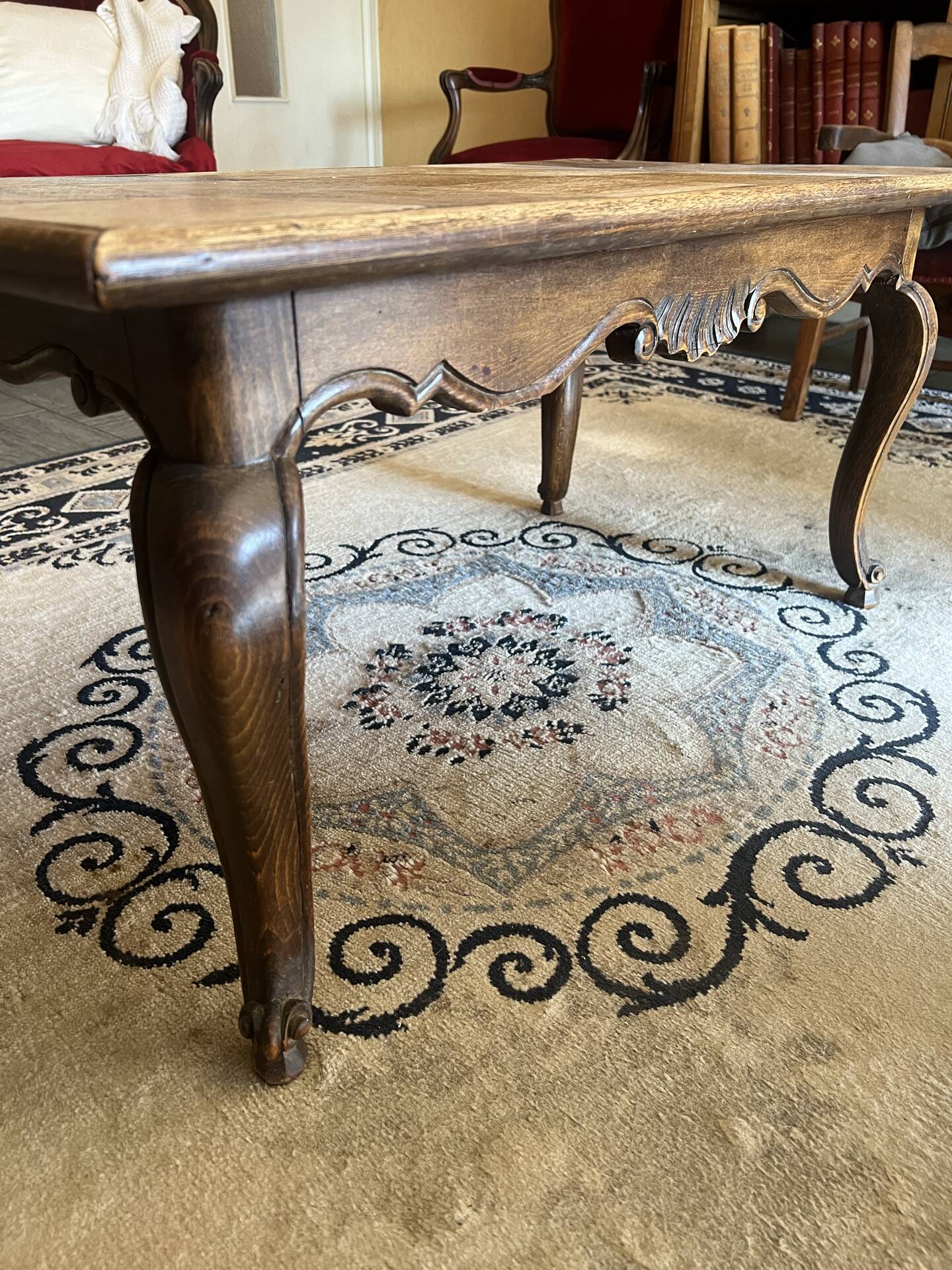 Antique coffee table with carved wood mouldings.