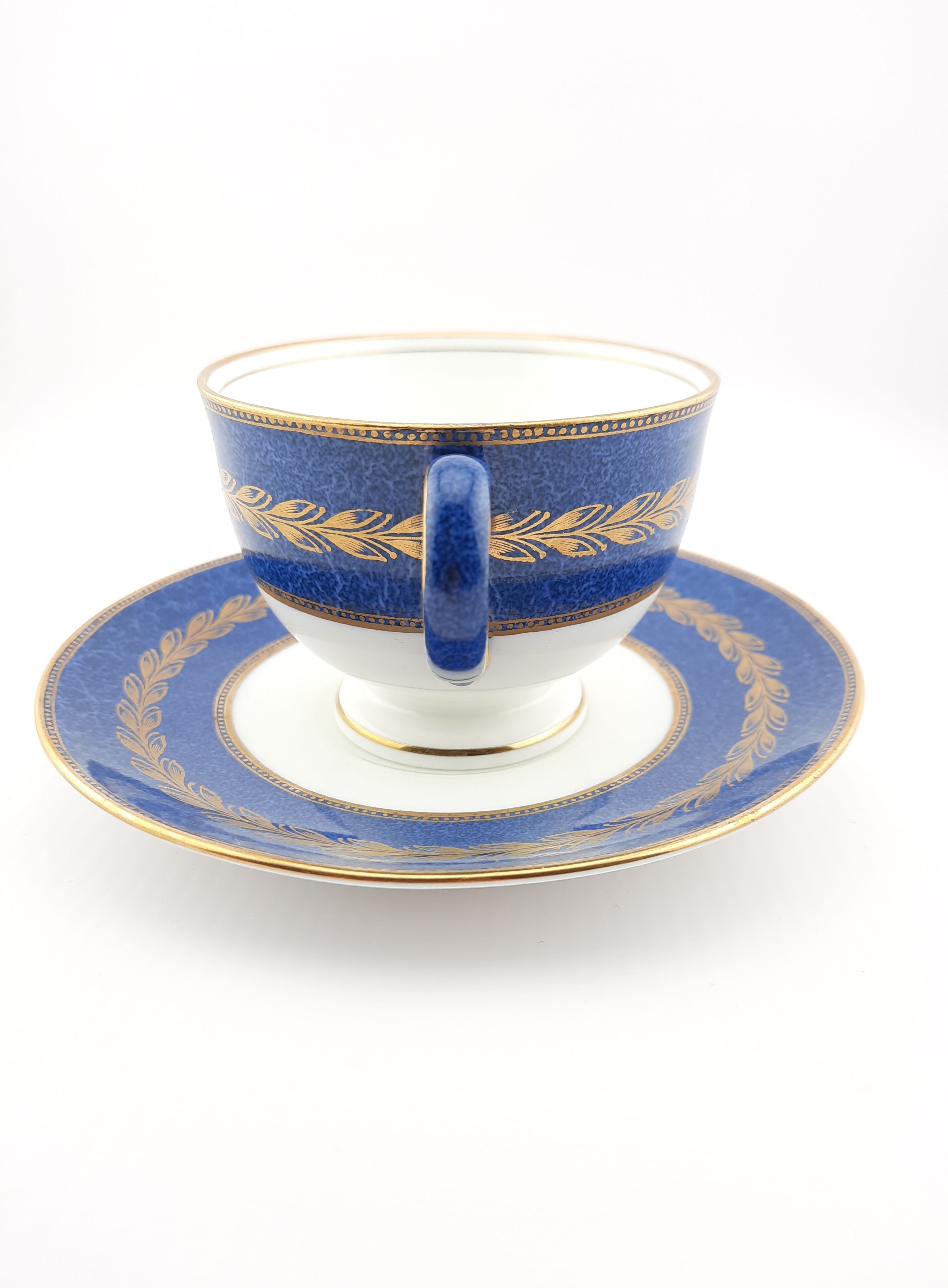 Antique Wedgwood teacup and saucer, bone china. Powder blue and gold English footed cup and saucer,