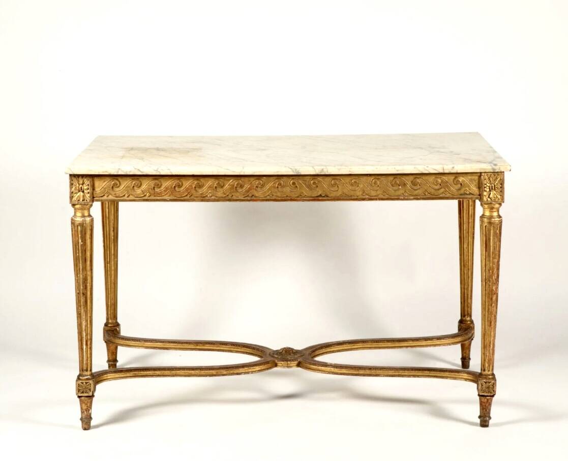 Golden carved wooden centre table with a white marble top.