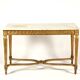 Golden carved wooden centre table with a white marble top.