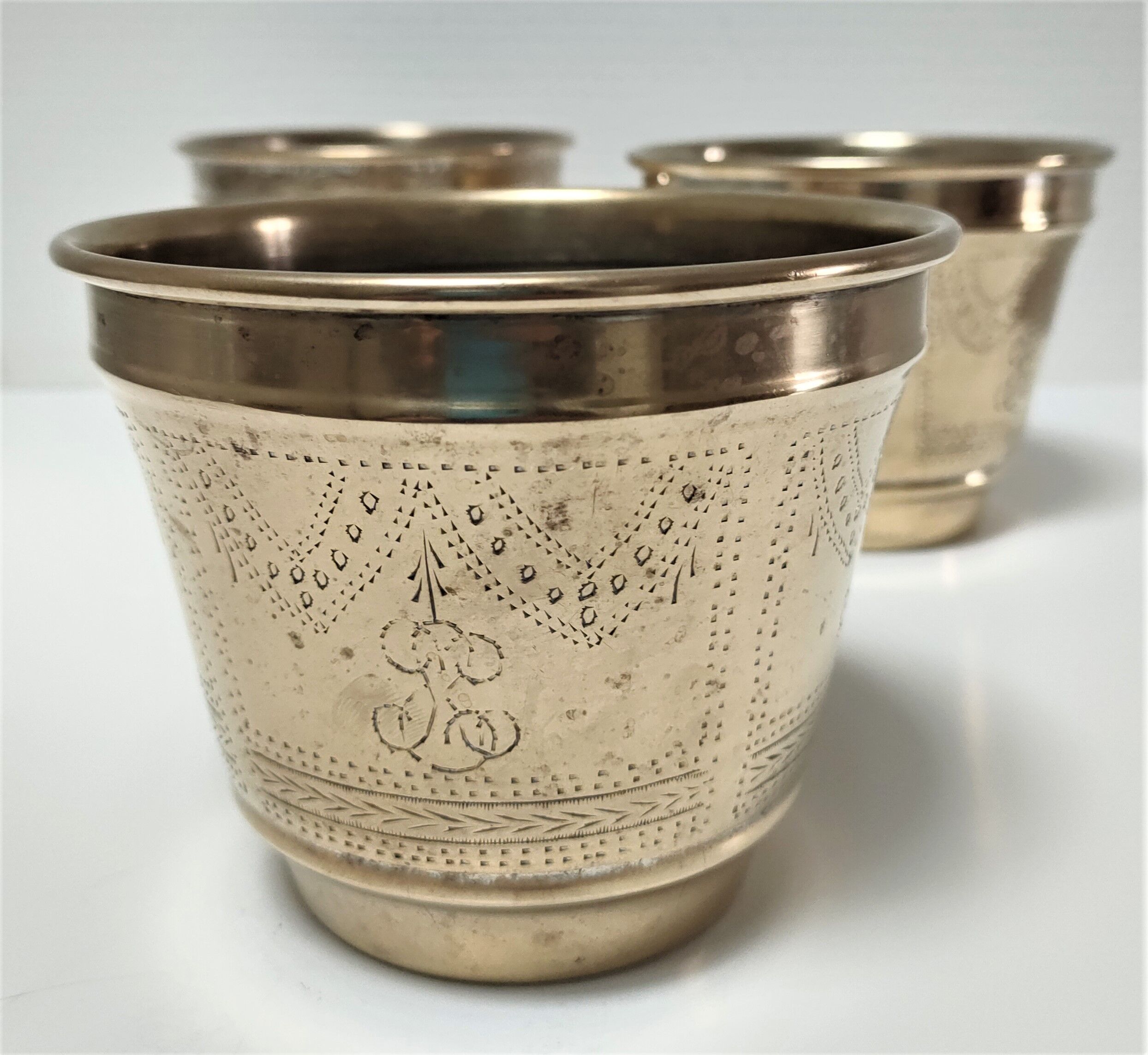 Three pot covers brass silver cover golden patina monogram early twentieth century