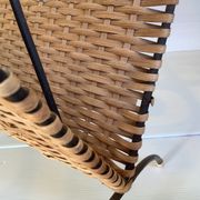 Old magazine rack in straw and black metal