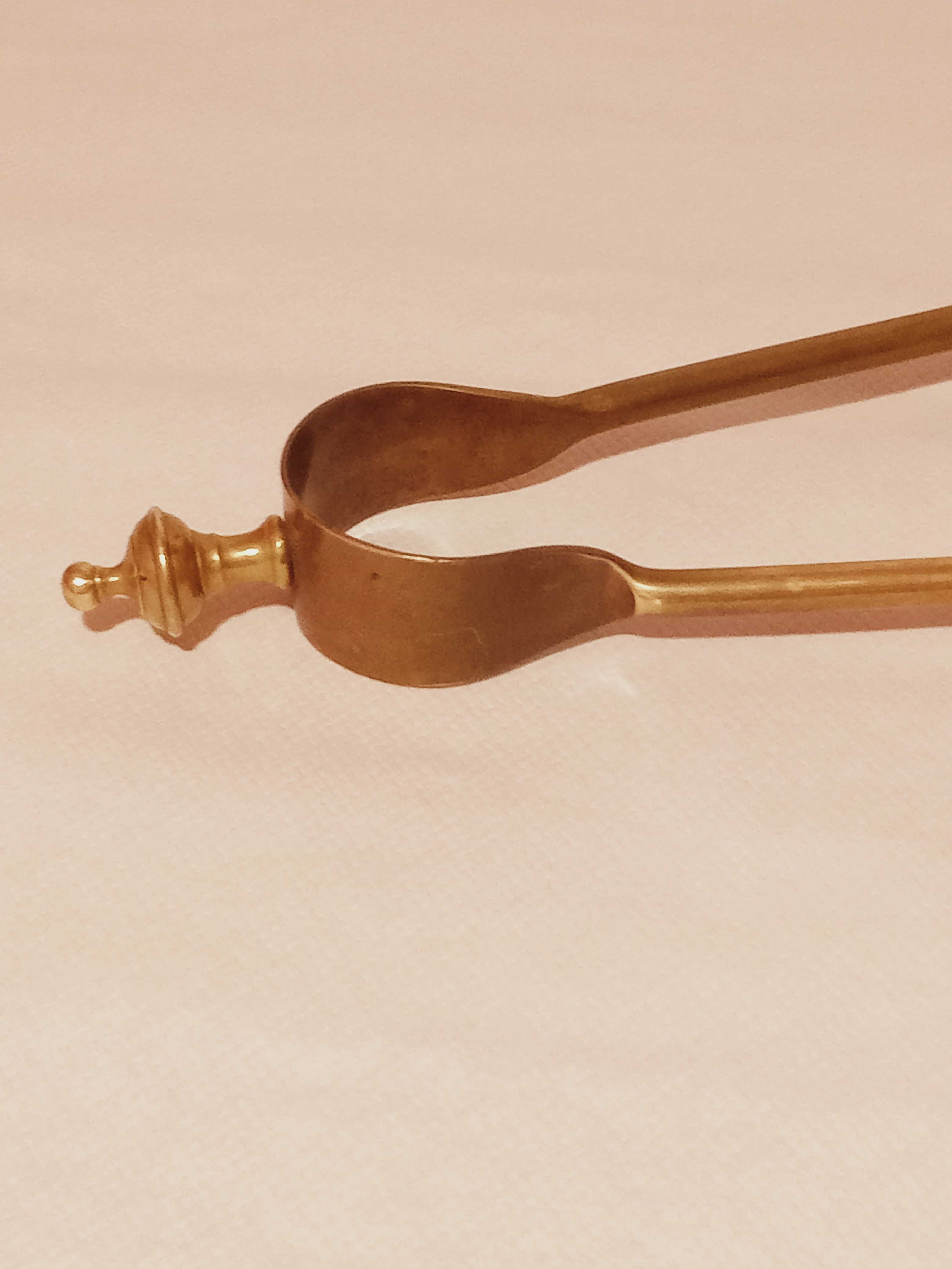 Old bronze or brass fireplace clamp