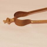 Old bronze or brass fireplace clamp
