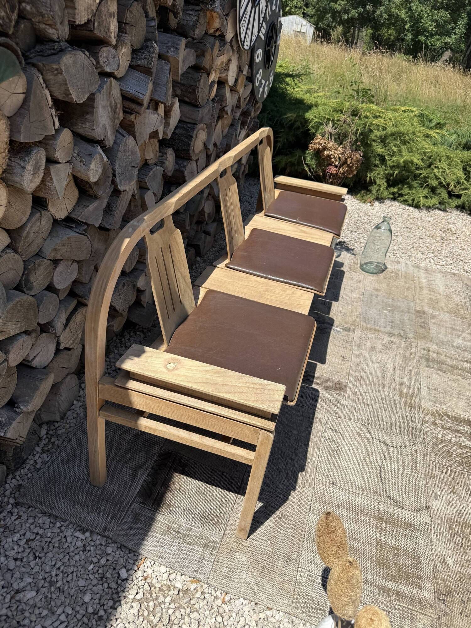 Baumann bench with wooden frame and faux leather seat.