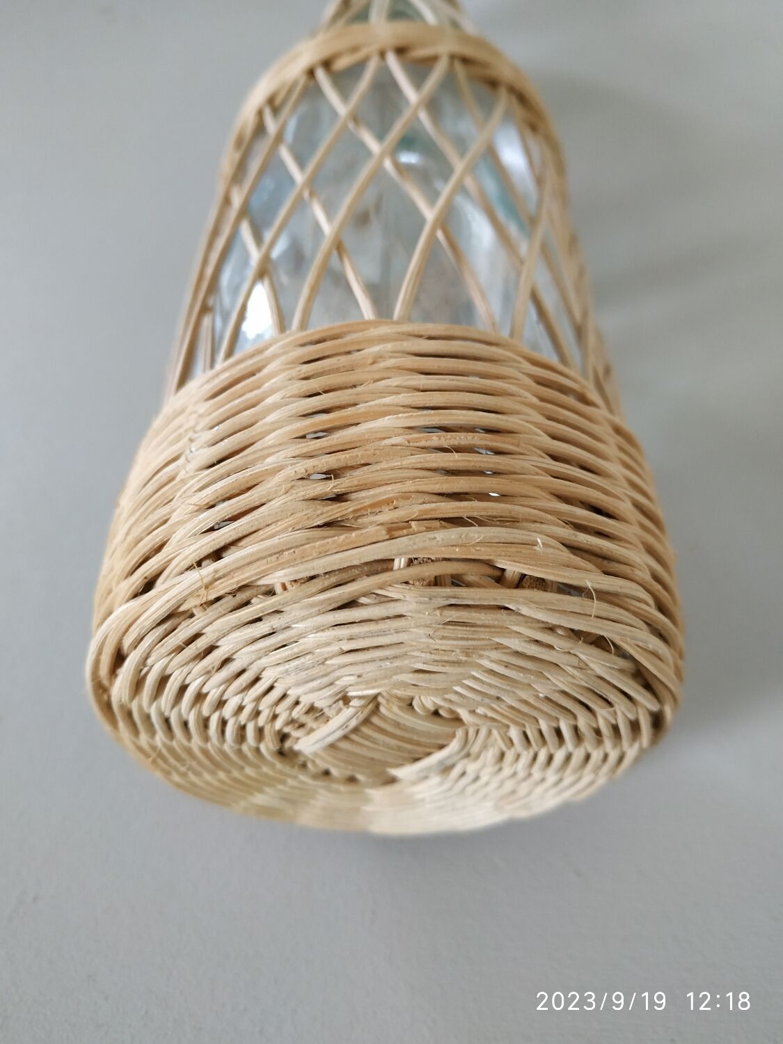 Glass and rattan bottle
