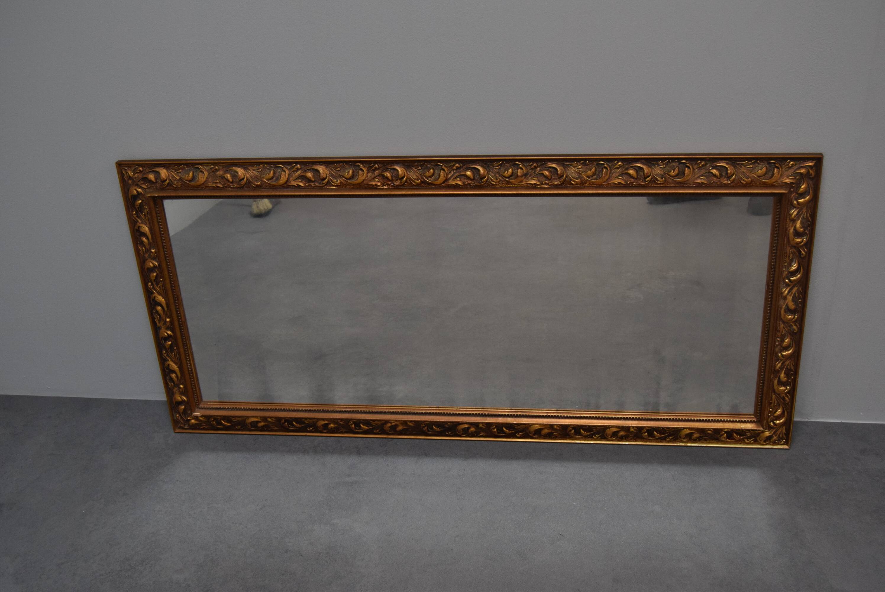 wall mirror in a decorative wooden frame.