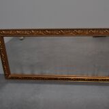 wall mirror in a decorative wooden frame.