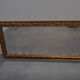 wall mirror in a decorative wooden frame.