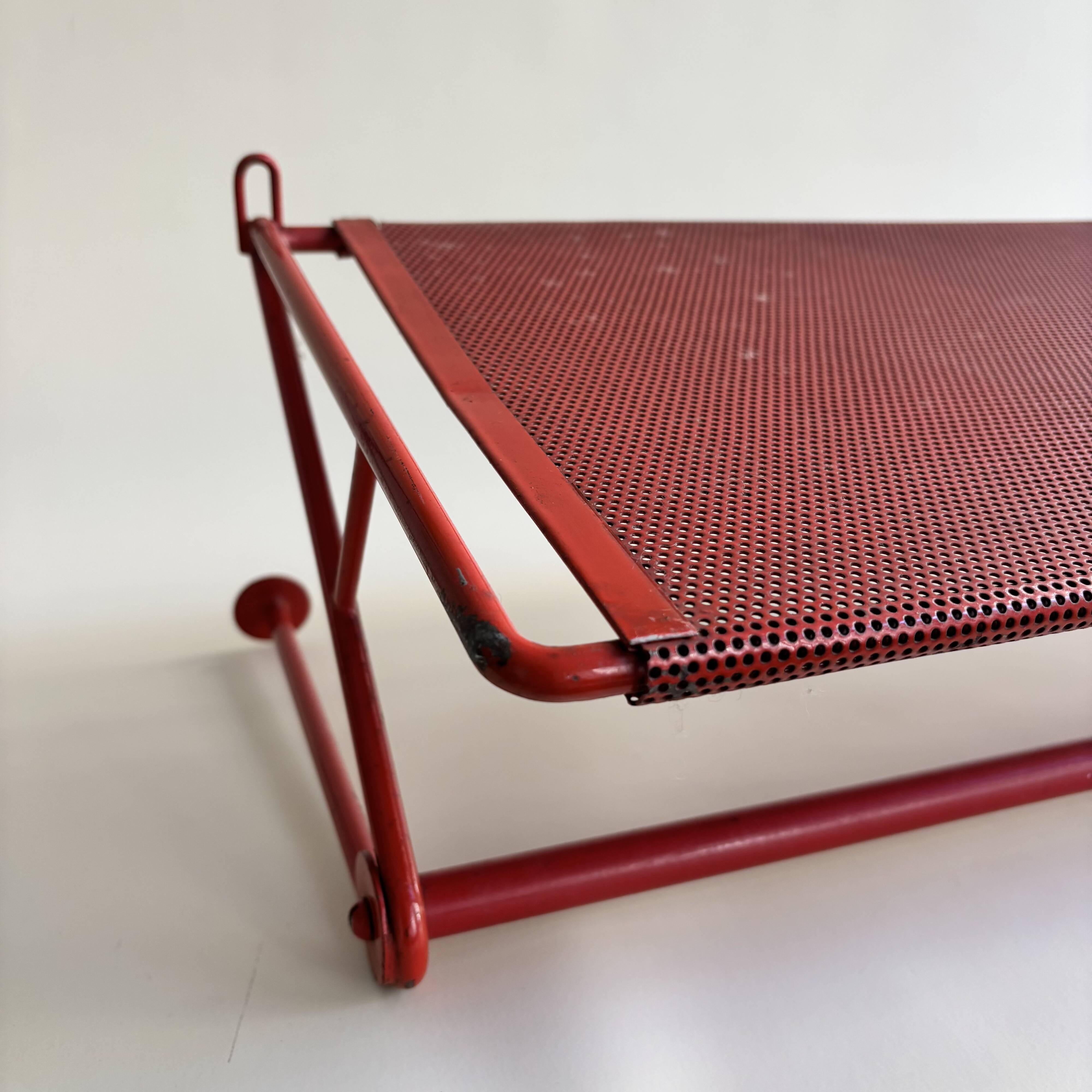 Vintage perforated red metal shelf
