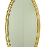 Miroir ovale doré de style Hollywood Regency