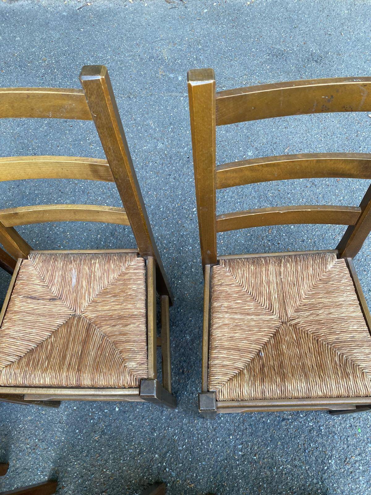 6 light solid wood chairs with high straw backs, farmhouse style.