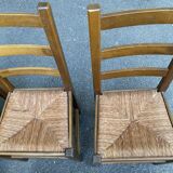 6 light solid wood chairs with high straw backs, farmhouse style.