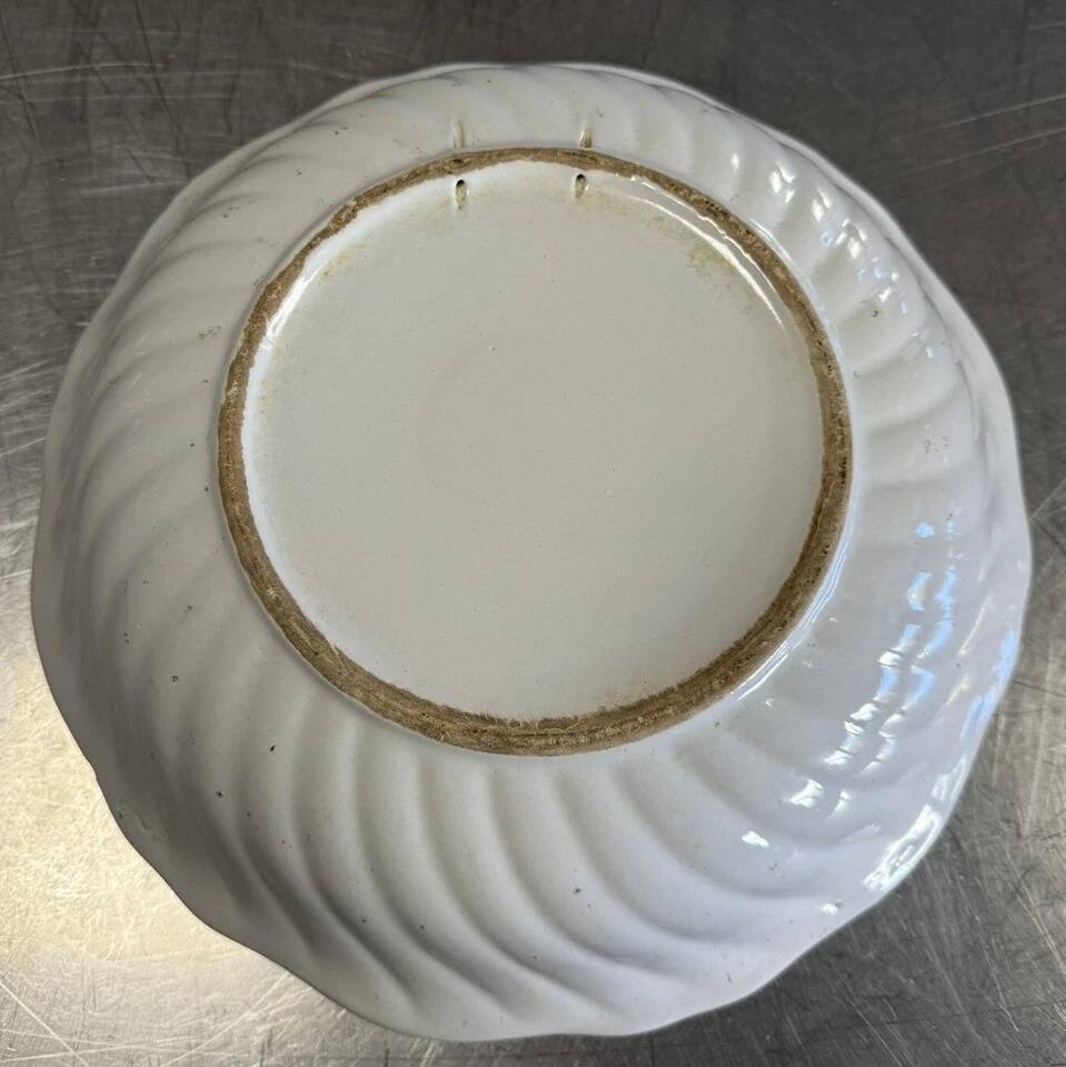 Large earthenware centerpiece dish with painted decoration of a drummer