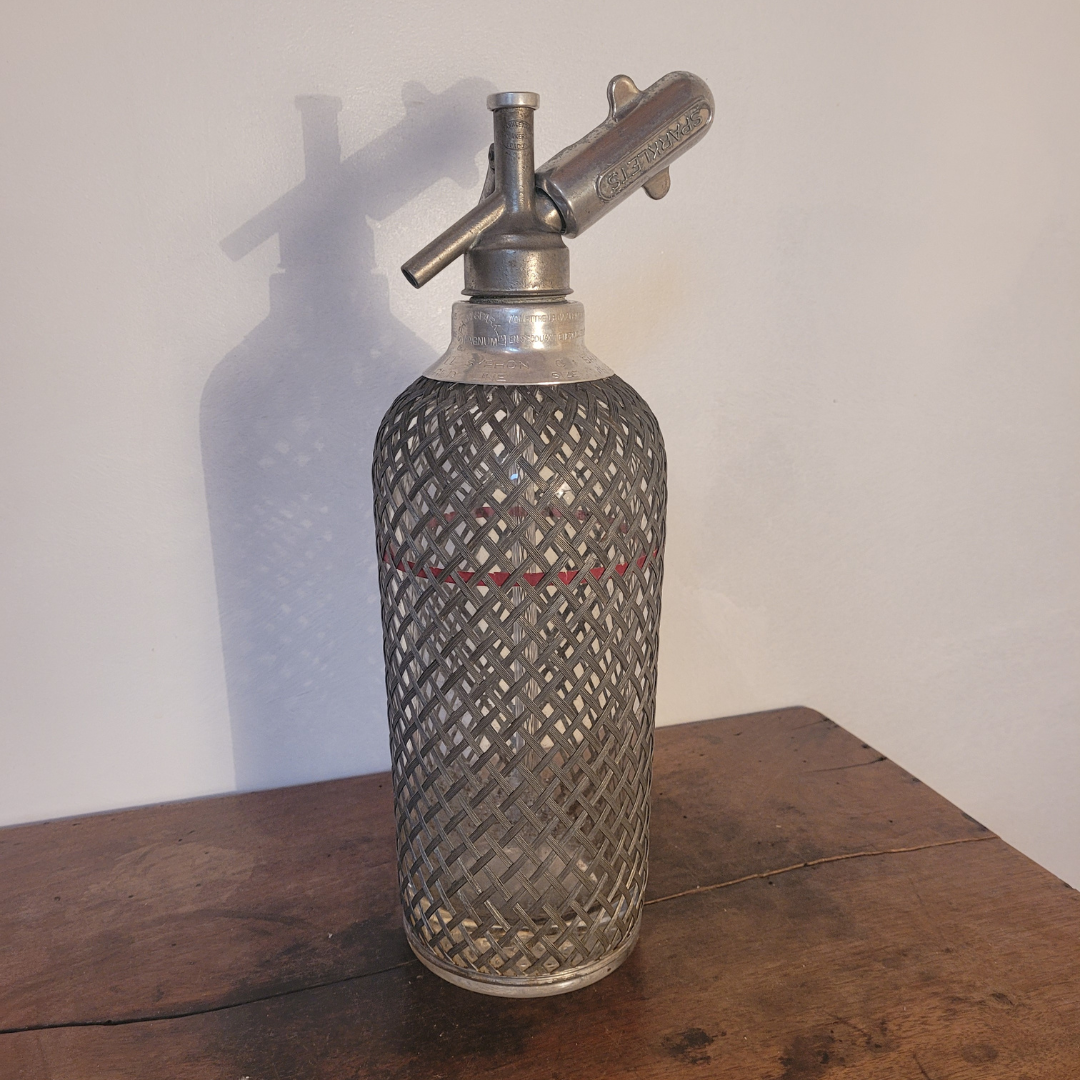 Old glass and metal siphon