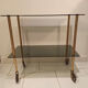 Vintage rolling dessert trolley with smoked glass trays and a golden base.
