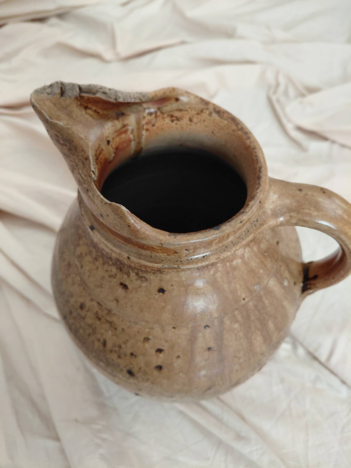 Old farm jug in glazed stoneware