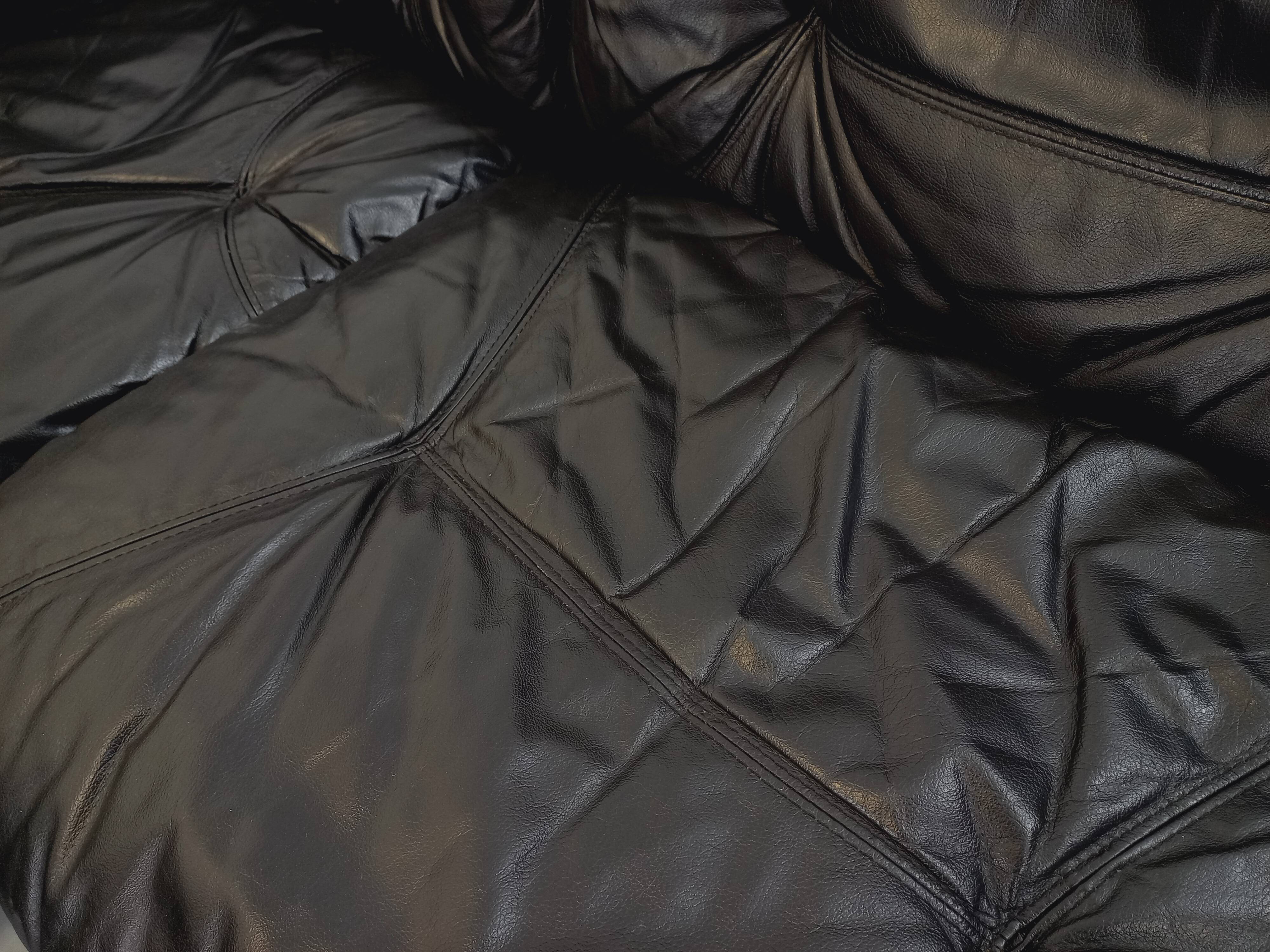 Vintage corner sofa composed of 3 modules in black leather with integrated bed.