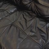 Vintage corner sofa composed of 3 modules in black leather with integrated bed.