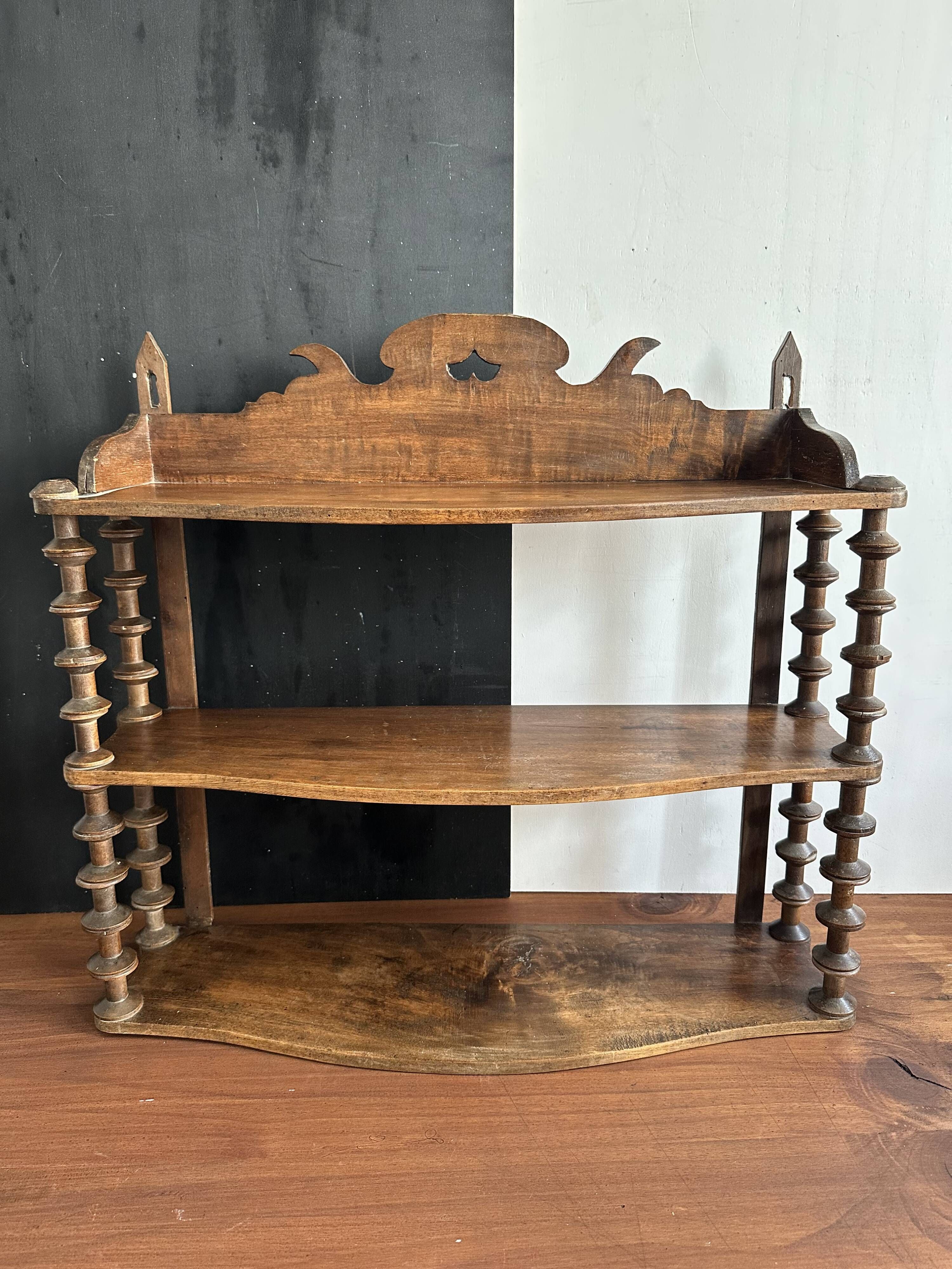 Antique wall shelf made of turned wood and spools of thread, late 19th century.