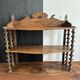 Antique wall shelf made of turned wood and spools of thread, late 19th century.