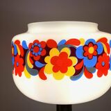 Table lamp with a vintage “flower power” glass globe and a gold base