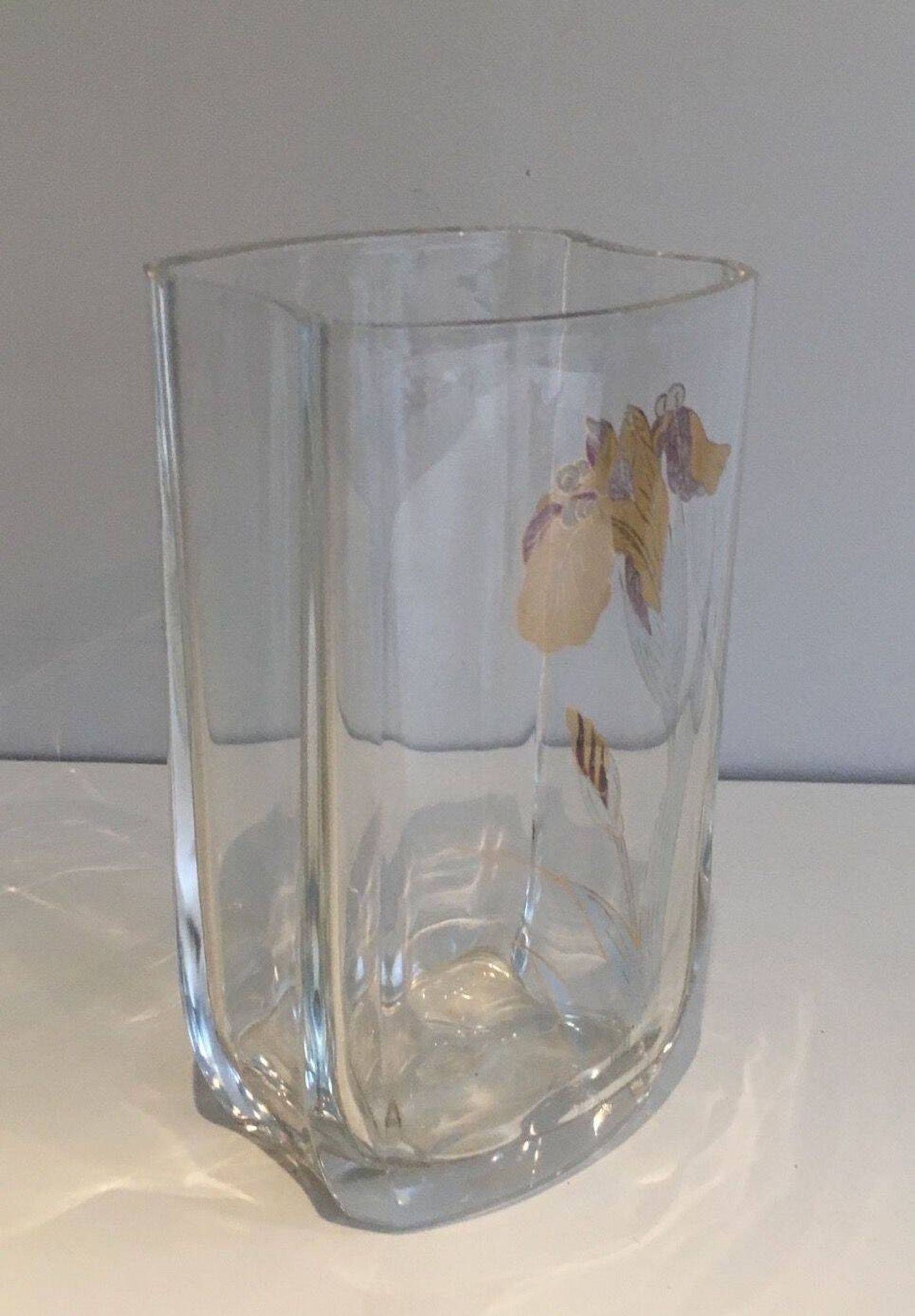 Glass vase with a decoration of a golden flower, around 1970.
