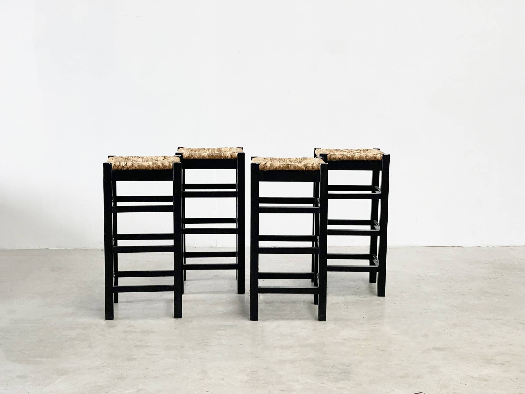 set of four rattan and wood barstools