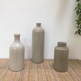 Trio of old sandstone bottles and jars