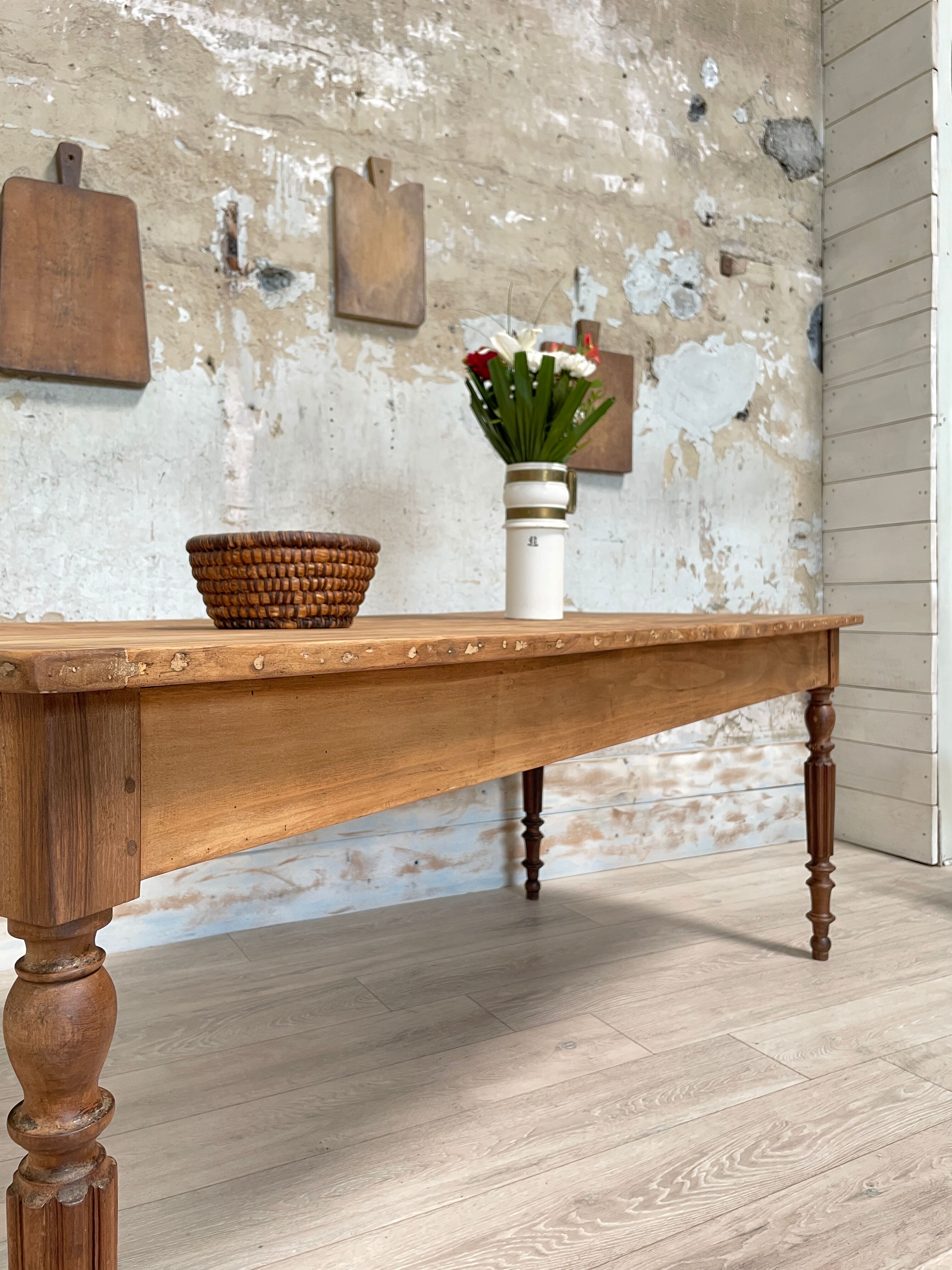 Vintage farmhouse table with turned legs.