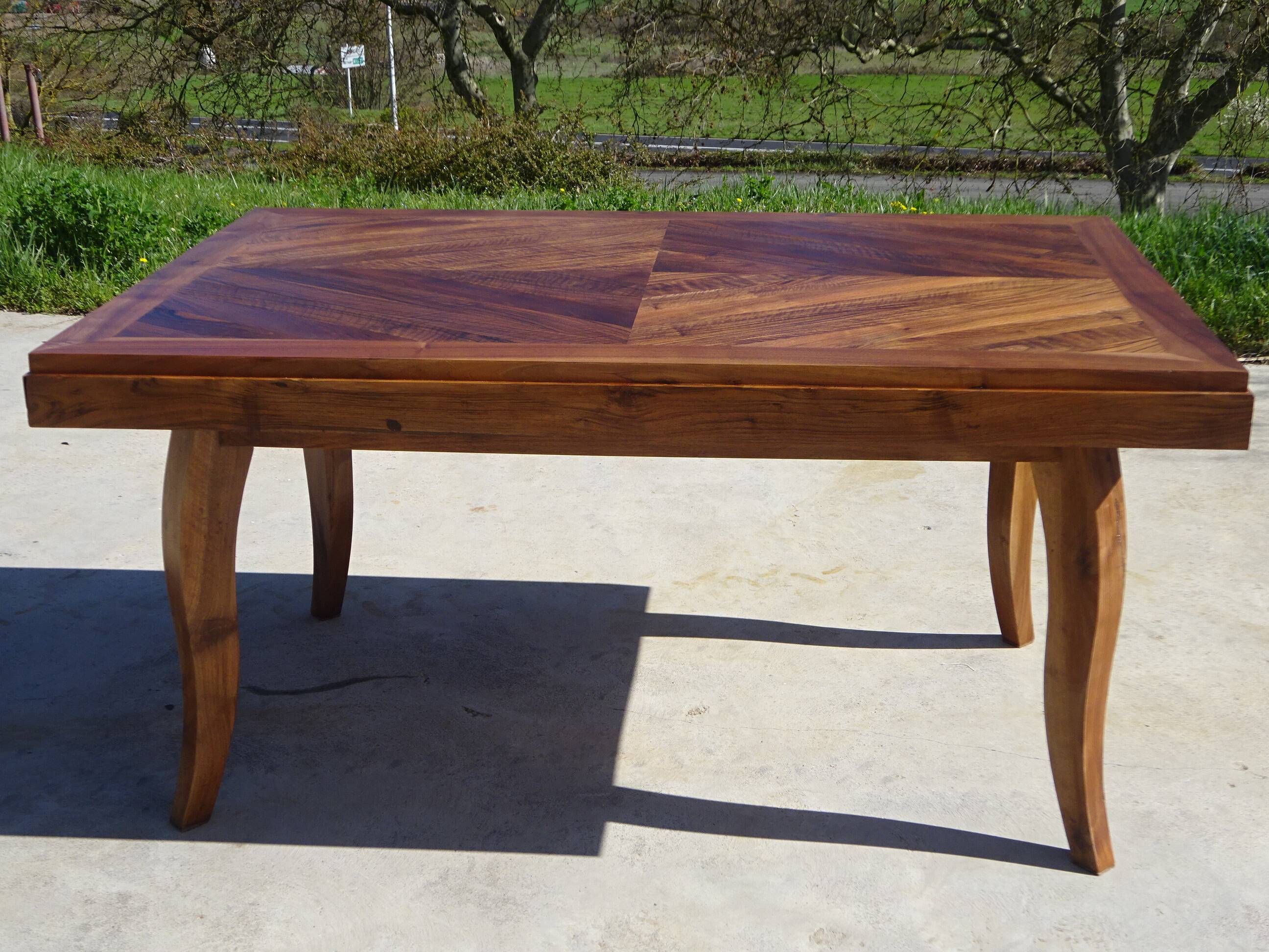 Antique solid walnut table with marquetry and extensions.