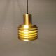 Hanging lamp in gold-colored aluminum with many layers of shades.