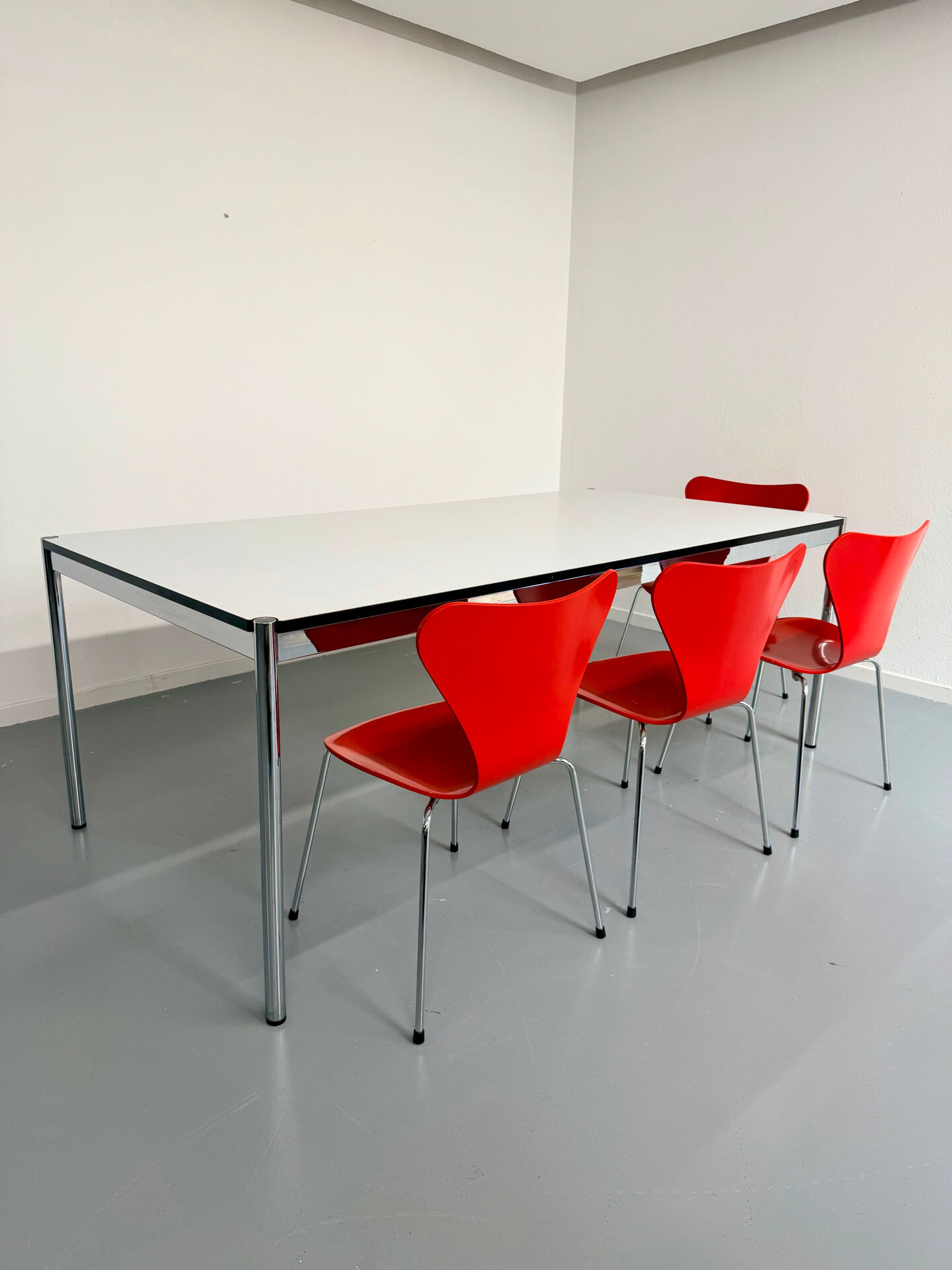 Large table design USM Haller with a white top and chrome structure.