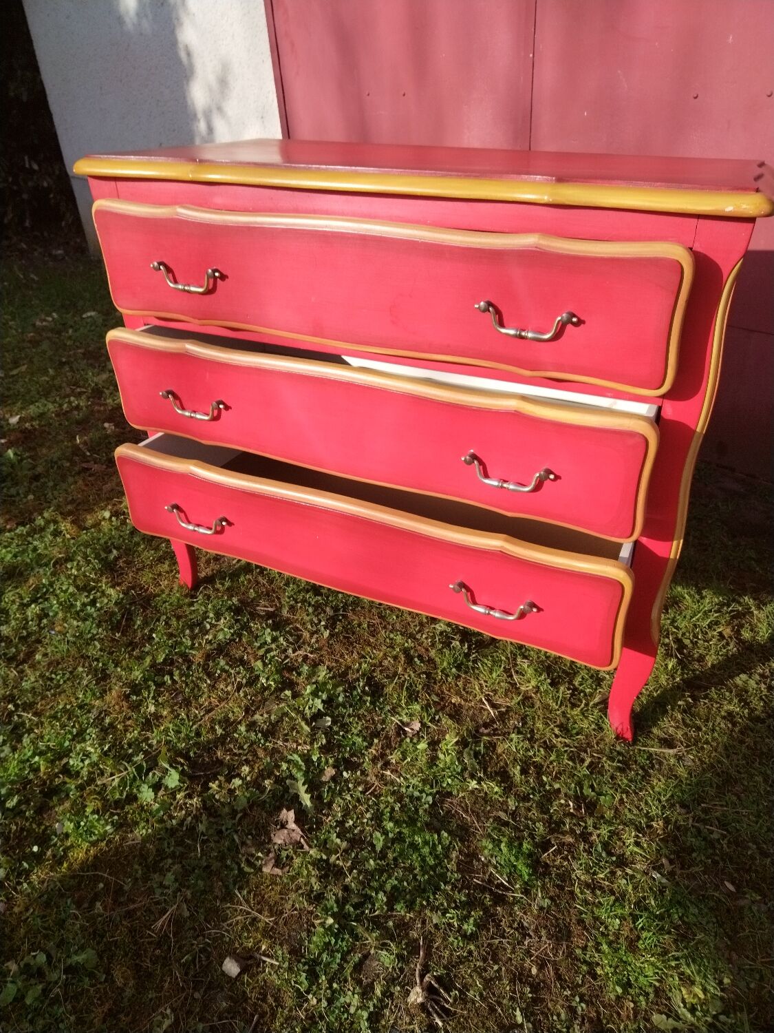 Matte gold and red patinated chest of drawers