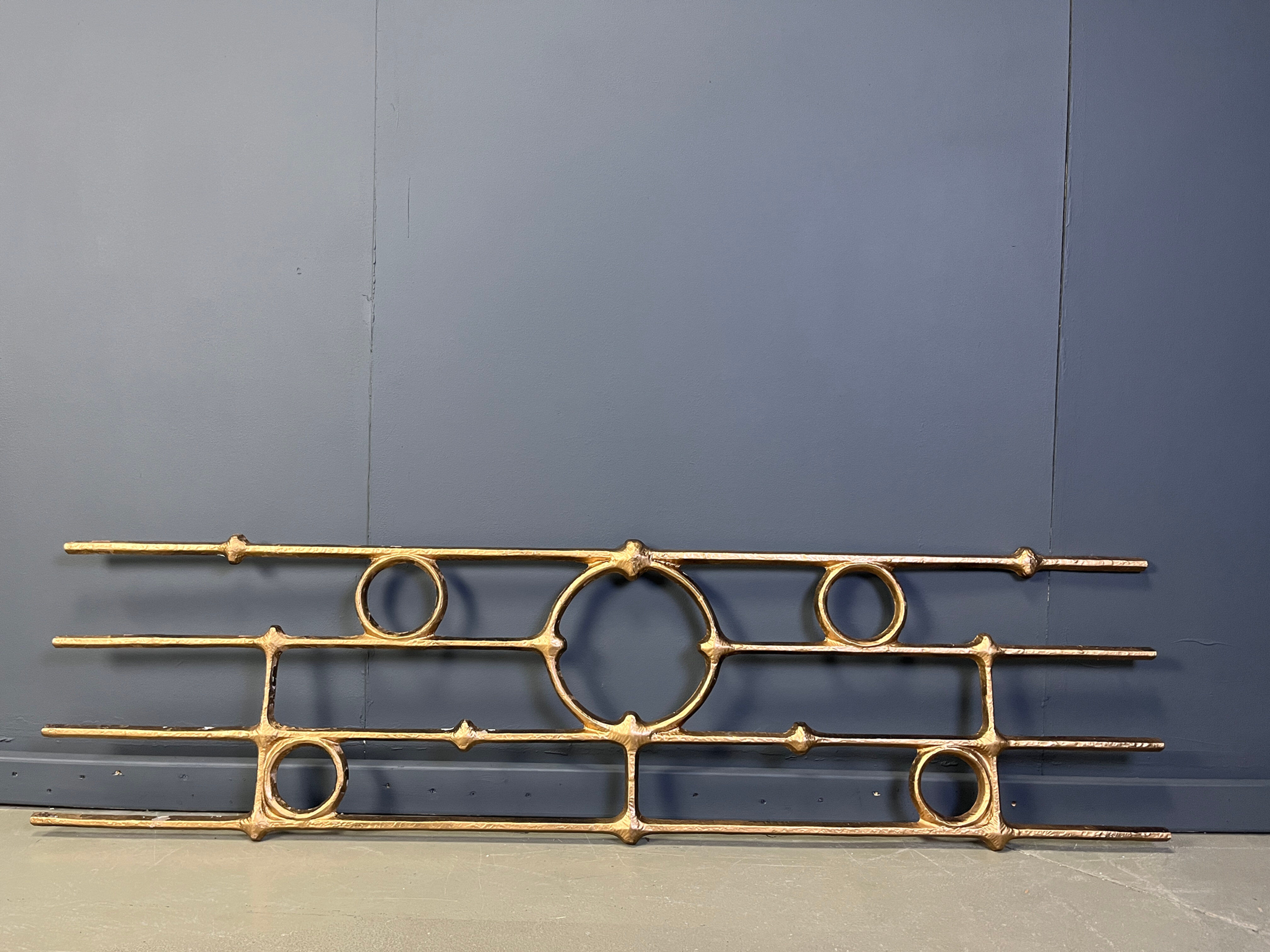 Architectural brutalist wall mounted sculpture made from cast metal.