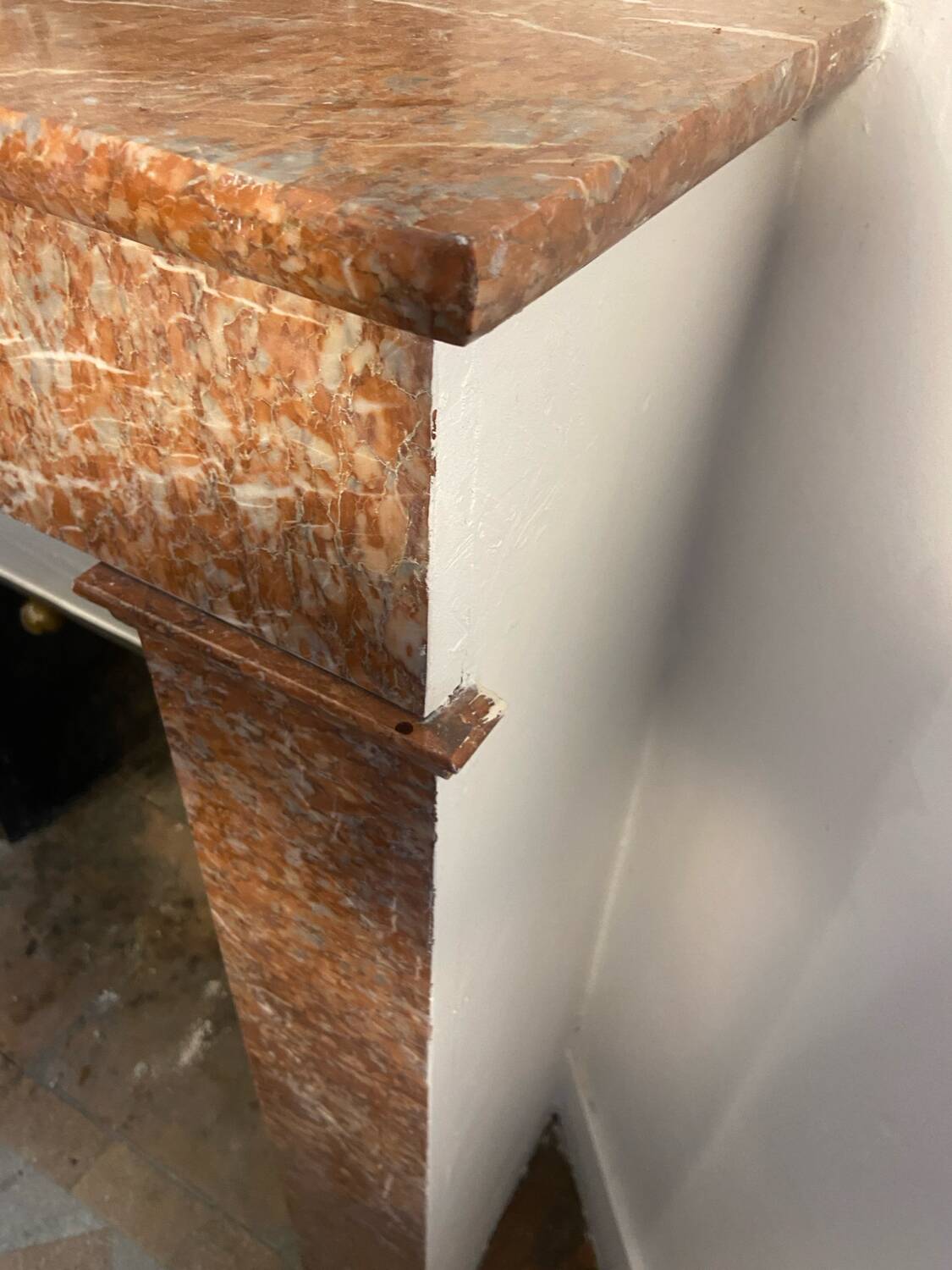 Marble fireplace surround with closed hearth frame.