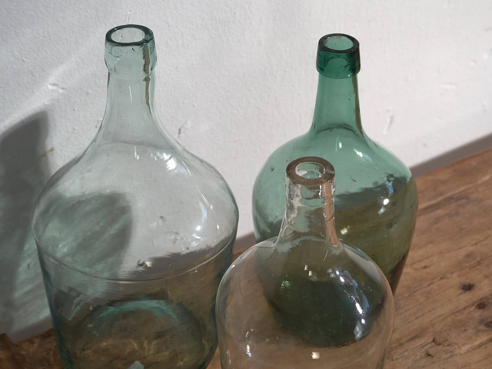 Antique colored demijohns (c.1920). Set of 3 pieces