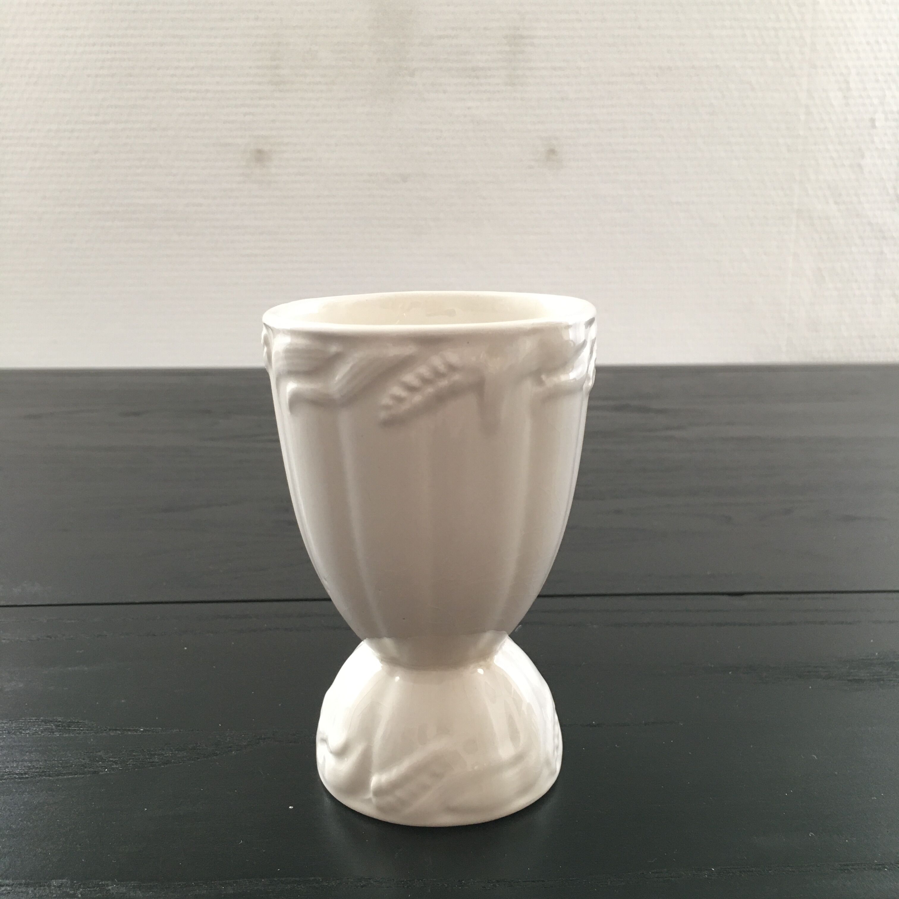White vase with wheat decoration.