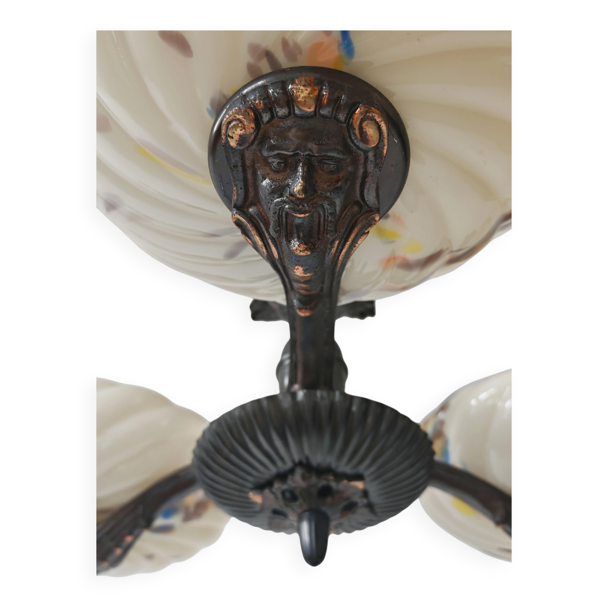 Art Deco bronze three-arm chandelier with marbled glass shades.