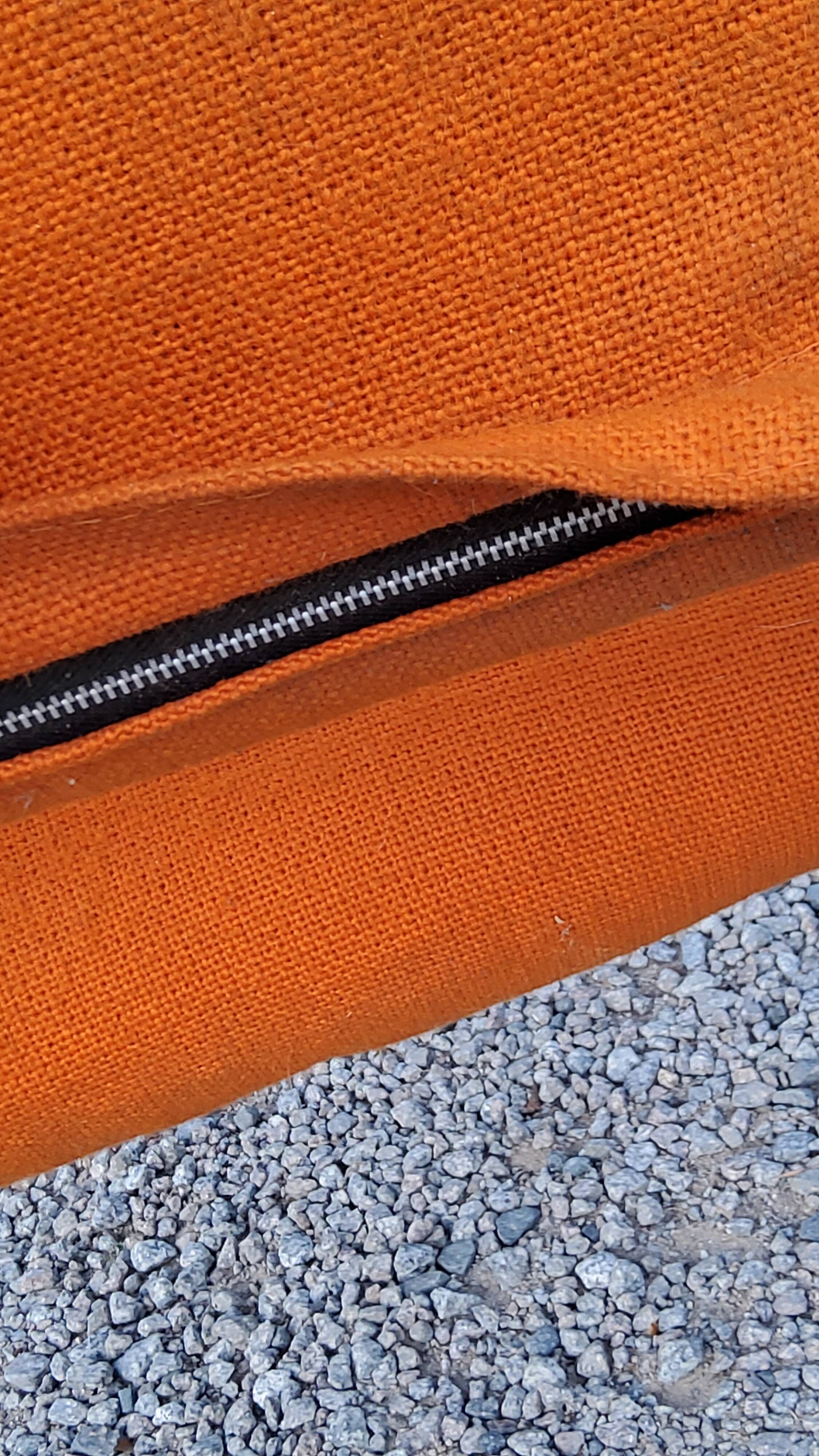 Pair of designer armchairs in orange fabrics and chrome tubes from the 70s