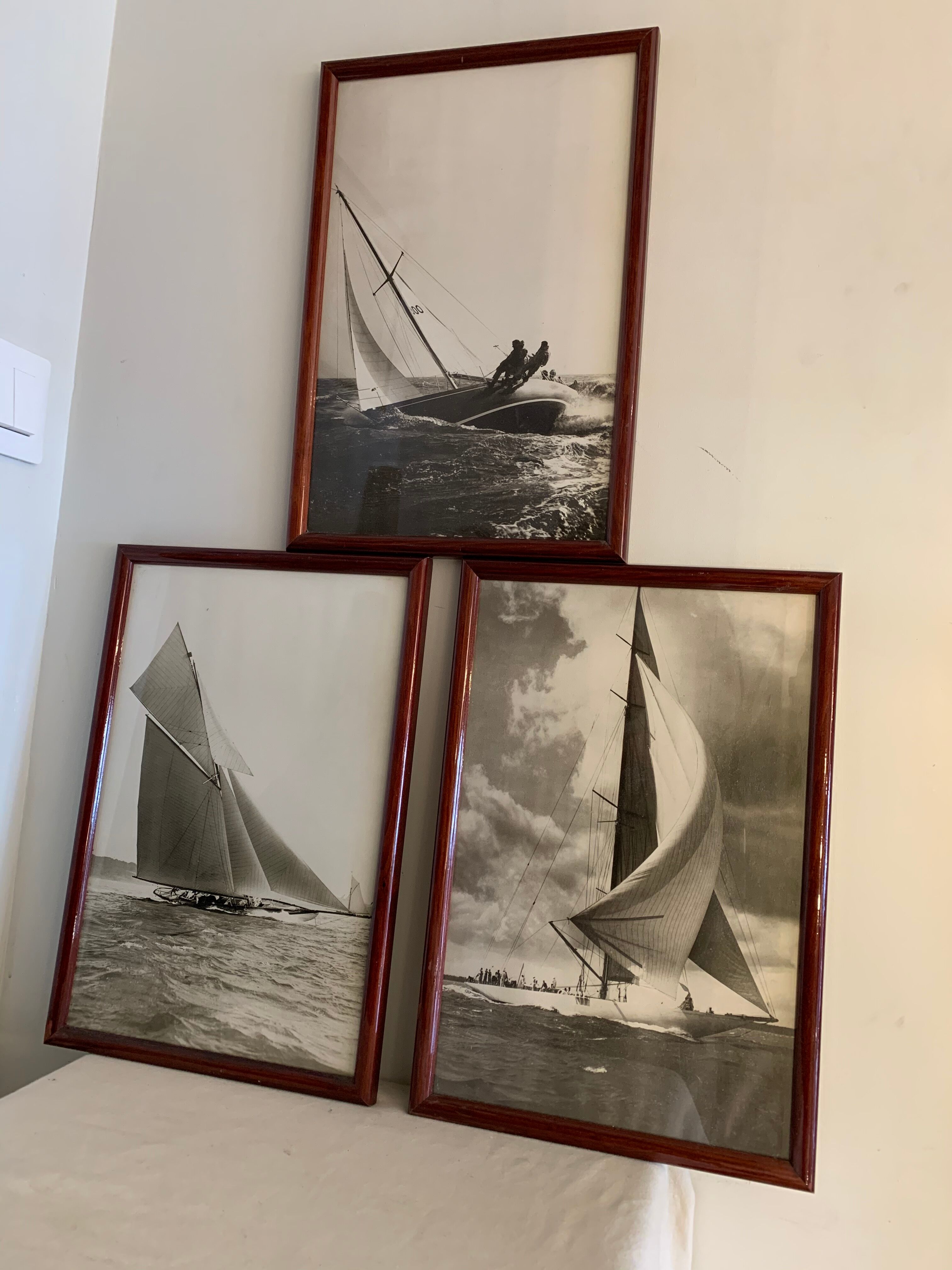 Three black and white-themed photographs sailboat boat with mahogany frame