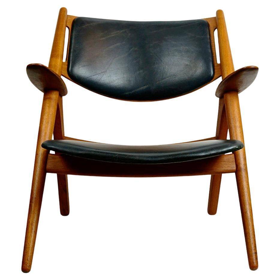 Chaise Lounge CH28 in Teak and Black Leather by Hans Wegner for Carl Hansen