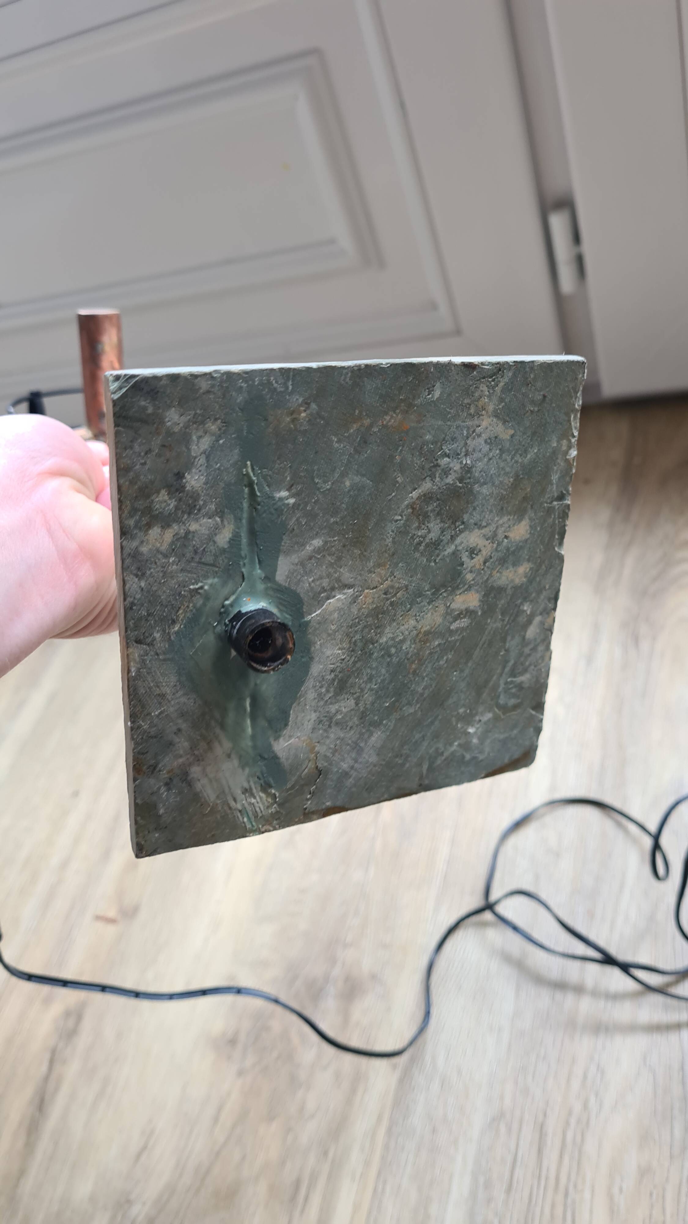 old lamp with stone base and copper arm