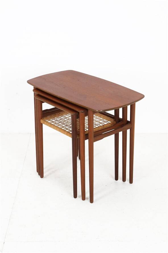 Rare set of three teak nesting tables with cane magazine rack / side tables / mid-century Danish modern design / 1950s / 1960s