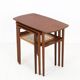 Rare set of three teak nesting tables with cane magazine rack / side tables / mid-century Danish modern design / 1950s / 1960s