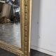 Golden mirror from the Napoleonic III era with shells and fluting.
