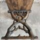 Dark brown wood and black cast-iron antique garden bench with weathered solid-wood seat