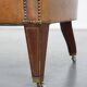 Antique, characteristic sheepskin chesterfield club chair on wheels