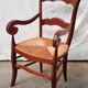 Old country armchair wood and natural straw